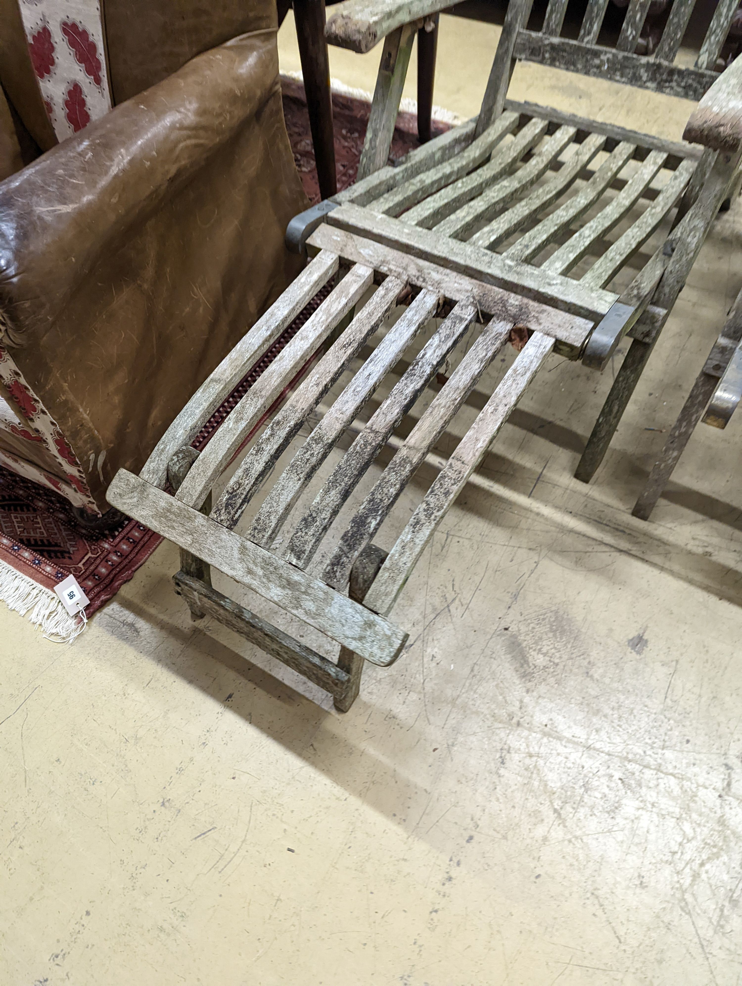 A pair of weathered teak garden steamer chairs, one lacks foot piece. H-93cm.